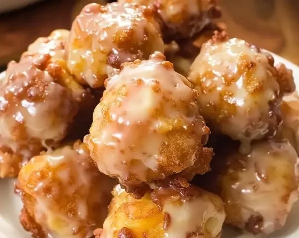 Freshly made Apple Fritter Bites with chunks of apple and a golden crust