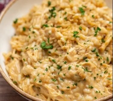 Delicious Chicken Rice Casserole topped with herbs and cheese