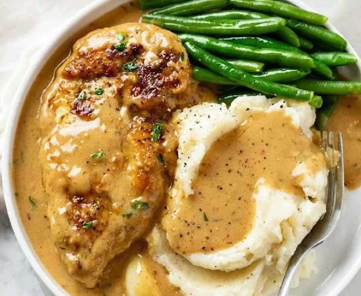 Delicious creamy garlic chicken served with herbs and vegetables