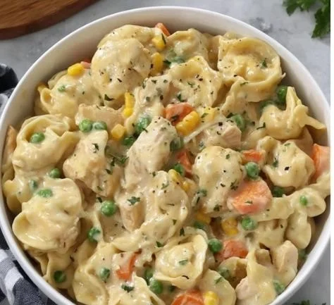 Crockpot Cheddar Chicken Pot Pie Tortellini served in a bowl with herbs