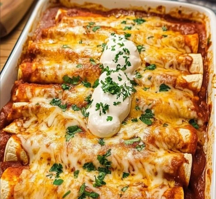 Delicious chicken enchiladas topped with sauce and cheese, ready to serve.