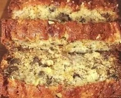 Hawaiian pineapple banana bread slice on a wooden table