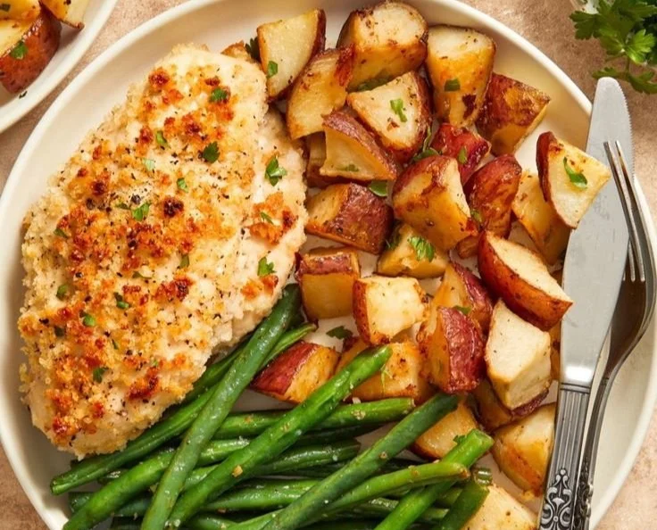 Delicious Parmesan Crusted Chicken on a sheet pan dinner with vegetables.