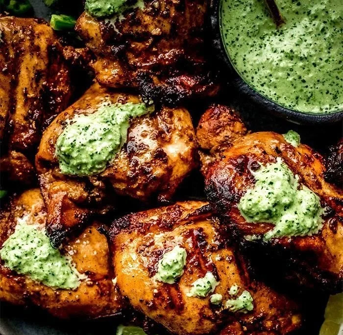 Peruvian grilled chicken served with creamy green sauce on a plate