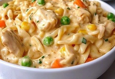 Delicious quick chicken pot pie pasta dish topped with herbs and served in a bowl.