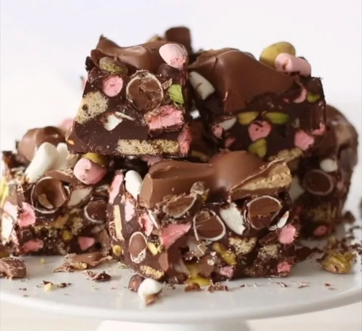 Delicious bowl of Rocky Road ice cream topped with marshmallows and nuts