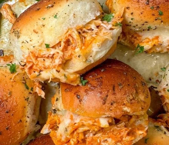 Delicious spicy buffalo chicken sliders ready to serve at a party