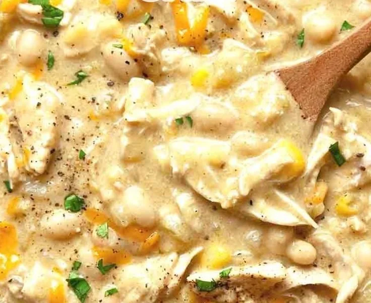 Delicious bowl of white chicken chili garnished with cilantro and served with tortilla chips.