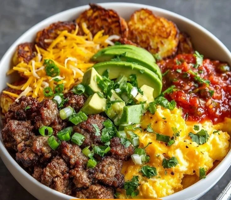 Delicious hash brown breakfast bowl topped with eggs and vegetables